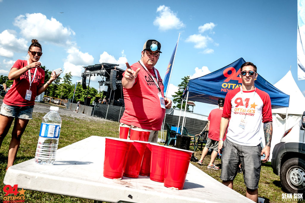 Ryan Lindsay and PJ of New Country 94 playing bean pong