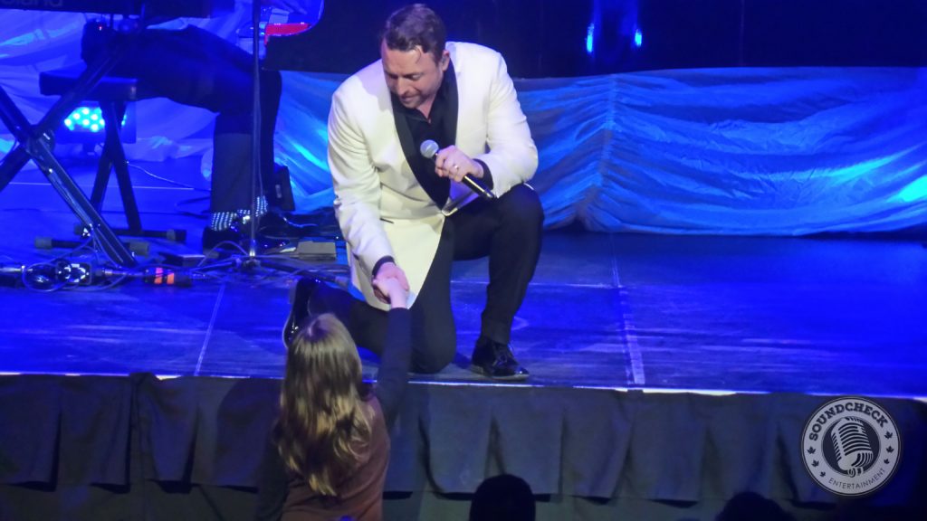 Johnny Reid sings to a fan at TD Place in Ottawa March 26, 2016