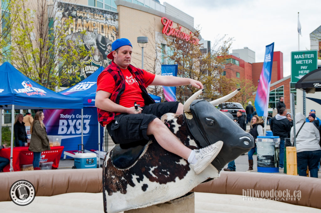 Riding the mechanical bull at the Bud Gardens Pre-show Tailgate Party 