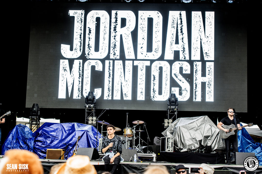 Jordan McIntosh sits on the side of the City Stage at RBC Bluesfest - photo by Sean Sisk